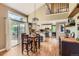Bright kitchen featuring wood floors, island, stainless steel appliances, with access to the outdoor deck at 5 Cliffrose, Littleton, CO 80127