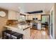 Well-lit kitchen featuring granite countertops, white cabinets, and stainless steel appliances at 5 Cliffrose, Littleton, CO 80127