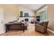 Inviting living room featuring a fireplace, comfortable seating, and ample natural light from a large window at 5 Cliffrose, Littleton, CO 80127