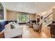 Inviting living room featuring hardwood floors, a large window, and cozy seating arrangement at 5 Cliffrose, Littleton, CO 80127