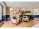 Comfortable living room with hardwood floors, two armchairs, and a staircase leading to the upper level at 5 Cliffrose, Littleton, CO 80127