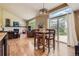 Open living space featuring hardwood floors, large windows, and a cozy fireplace with a white brick surround at 5 Cliffrose, Littleton, CO 80127
