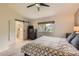 Cozy main bedroom featuring a sliding barn door to an ensuite bathroom with a view of the backyard at 5 Cliffrose, Littleton, CO 80127