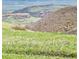 Scenic view of rolling hills and a lush green valley, with beautiful landscaping at 5 Cliffrose, Littleton, CO 80127