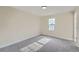 Bright bedroom with a large window, carpet, and neutral walls at 2888 S Fundy St, Aurora, CO 80013