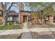 Charming home exterior featuring brick accents, mature trees, and a well-maintained pathway to the entrance at 2685 S Dayton Way # 67, Denver, CO 80231