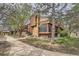 Inviting two-story home with brick accents, mature trees, and a well-maintained lawn on a sunny day at 2685 S Dayton Way # 67, Denver, CO 80231