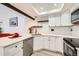 Stylish kitchen featuring white cabinets, quartz countertops, and stainless steel appliances at 2685 S Dayton Way # 67, Denver, CO 80231