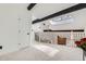 Bright loft area with skylight, dark wood beams, and staircase with metal railing at 2685 S Dayton Way # 67, Denver, CO 80231