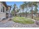 Picturesque backyard with tall trees, a rock garden, and a well-maintained lawn at 1766 Summerglow Ln, Monument, CO 80132
