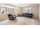 Cozy basement den with a classic leather sofa, armchair, and natural light from the window at 1766 Summerglow Ln, Monument, CO 80132