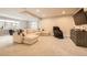 Spacious basement featuring a large sectional sofa, massage chair, and a media console, perfect for relaxation at 1766 Summerglow Ln, Monument, CO 80132