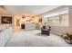 Basement with a stylish bar area featuring a brick backsplash, open shelving, and a view to an adjacent room at 1766 Summerglow Ln, Monument, CO 80132
