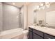 Modern bathroom featuring a subway tile shower, vanity with ample counter space, and contemporary lighting at 1766 Summerglow Ln, Monument, CO 80132