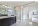 Bright bathroom features a double vanity, sleek mirrors, and a glass-enclosed shower, perfect for relaxation at 1766 Summerglow Ln, Monument, CO 80132