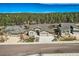 Charming exterior elevation featuring stone accents, a three car garage and immaculate landscaping at 1766 Summerglow Ln, Monument, CO 80132