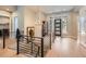 Bright foyer with wood floors, modern chandelier, and staircase featuring iron railings at 1766 Summerglow Ln, Monument, CO 80132