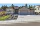 Attractive stucco home featuring a three-car garage, stone accents, and mature trees at 1766 Summerglow Ln, Monument, CO 80132