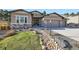 Charming stucco home with stone accents, manicured front yard, and inviting curb appeal at 1766 Summerglow Ln, Monument, CO 80132