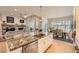 Open kitchen with a granite island, stainless appliances, and adjacent living and dining areas at 1766 Summerglow Ln, Monument, CO 80132
