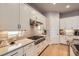 Bright kitchen features sleek white cabinets, stainless steel appliances, and a subway tile backsplash at 1766 Summerglow Ln, Monument, CO 80132