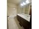Bathroom featuring double sinks, tile flooring and shower, with warm-toned vanity at 12973 E Cornell Ave, Aurora, CO 80014