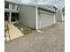 Gray two-story townhome with two-car garage, inviting entrance, and trimmed landscaping at 12973 E Cornell Ave, Aurora, CO 80014
