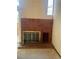 Living room featuring a brick fireplace with glass doors and a convenient storage niche at 12973 E Cornell Ave, Aurora, CO 80014