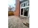 View of the home's brick patio featuring a brick wall and access via sliding glass door at 12973 E Cornell Ave, Aurora, CO 80014