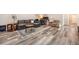 Finished basement with L-shaped sofa, office area, and hardwood floors at 921 Raleigh St, Denver, CO 80204