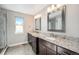 Bathroom features double vanity, granite countertop, and large mirror at 921 Raleigh St, Denver, CO 80204