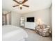 Main bedroom with large dresser, ceiling fan and sitting area at 921 Raleigh St, Denver, CO 80204