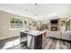 Open concept kitchen features island with seating, stainless steel appliances, and white quartz countertops at 921 Raleigh St, Denver, CO 80204