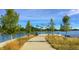 Serene lakefront walkway with benches and shade at 921 Raleigh St, Denver, CO 80204