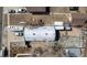 Directly above aerial view of unique metal Quonset hut style home with gravel landscaping at 410 Goodrich Ave, Platteville, CO 80651