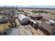 Unique metal Quonset hut style home with rock landscaping in suburban neighborhood setting at 410 Goodrich Ave, Platteville, CO 80651