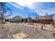 Large gravel backyard showcasing a unique setup with multiple corrugated metal buildings at 410 Goodrich Ave, Platteville, CO 80651