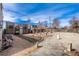 Spacious gravel backyard featuring unique metal details and multiple structures at 410 Goodrich Ave, Platteville, CO 80651