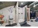 Modern bathroom with walk-in shower, toilet, and patterned floors at 410 Goodrich Ave, Platteville, CO 80651