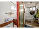 Unique bath with artistic decor, a sliding privacy screen, and a single vanity at 410 Goodrich Ave, Platteville, CO 80651