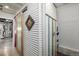 Unique bathroom featuring a sliding barn door, corrugated metal walls and a beautifully tiled shower at 410 Goodrich Ave, Platteville, CO 80651