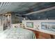 Stylish bedroom features a unique metal ceiling, complemented by artwork and decor at 410 Goodrich Ave, Platteville, CO 80651
