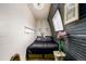 Stylish bedroom boasts corrugated metal walls, a comfortable bed and unique decor elements at 410 Goodrich Ave, Platteville, CO 80651