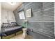 Stylish bedroom boasts corrugated metal walls, a comfortable bed and unique decor elements at 410 Goodrich Ave, Platteville, CO 80651