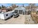 Unique home featuring a Quonset hut style building, RV, and stylish metal and rock landscaping at 410 Goodrich Ave, Platteville, CO 80651