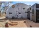 Unique corrugated metal home with circular details, small yard, and eclectic backyard design at 410 Goodrich Ave, Platteville, CO 80651