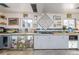 Well-lit kitchen featuring stainless steel appliances, concrete countertops, and a unique wall decor at 410 Goodrich Ave, Platteville, CO 80651