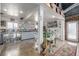 The kitchen features a bar with seating, stainless steel beverage cooler, and unique concrete floors at 410 Goodrich Ave, Platteville, CO 80651