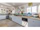 An eclectic kitchen featuring updated cabinetry, concrete counters, and artistic décor elements at 410 Goodrich Ave, Platteville, CO 80651