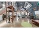 Spacious open-concept living room in a Quonset-style home with a mezzanine and modern decor at 410 Goodrich Ave, Platteville, CO 80651